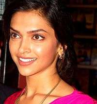 Deepika Padukone is smiling away from the camera