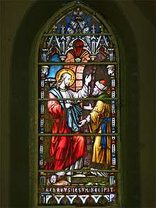 Stained glass rendition of Zacchaeus receiving Jesus into his house.