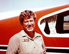 Mary Barr next to her transport plane, 1975