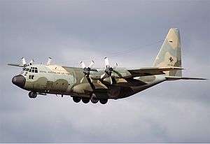 Colour photo of a four-engined aircraft painted in a camouflage pattern