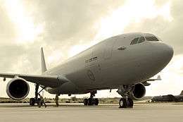 Grey-coloured twin-engined jet on runway