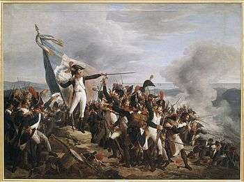 Painting shows a man in a blue uniform with white breeches standing on a mountaintop amid a crowd of soldiers. He gestures dramatically with his sword as he holds a French tricolor. Some of the soldiers are firing downhill.