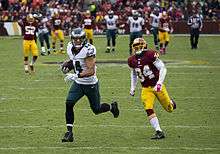 Riley Cooper, a white, 28-year-old man, runs with a football.