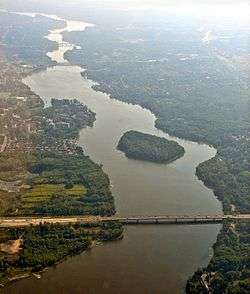 Aerial view looking east, of Rivière des Prairies with Louis Bisson Bridge in the foreground. The island "Ile aux Chats" can be seen near the center.