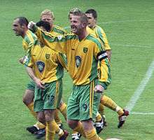 Picture of footballer Iwan Roberts, with a number of other players visible in the background