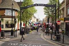 Metal archway spanning Roman Road for Roman Road Market