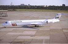 A medium jetliner with an all-white body andcolored stripes