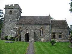 Stone building with square tower.