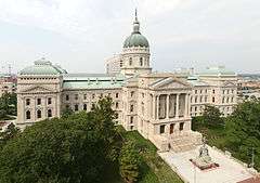 A large white building with two long sweeping wings