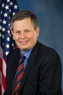 Upper-body portrait of a man in a suit.