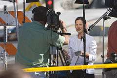 waist high portrait of a TV cameraman and reporter