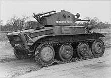 The side and rear of a Tetrarch light tank, with trees in the background