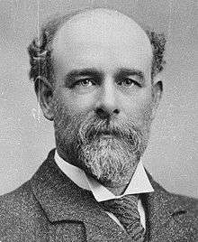 Portrait photo of Thomas Henry Davey, showing him with a bald head and a full beard