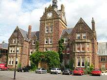 Large stone building with a clock tower on top