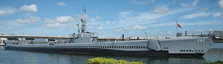 Full side photograph of USS Bowfin at dock.