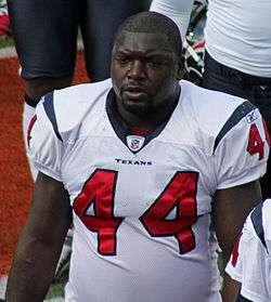  A football player standing without a helmet