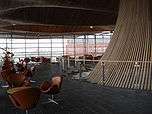 Chairs and tables surrounding a large wooden funnel