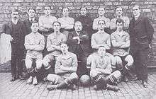 Players and staff pose for a photograph